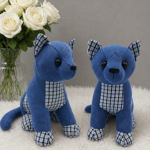 Two blue memory sitting cats with checked fabric details and white roses