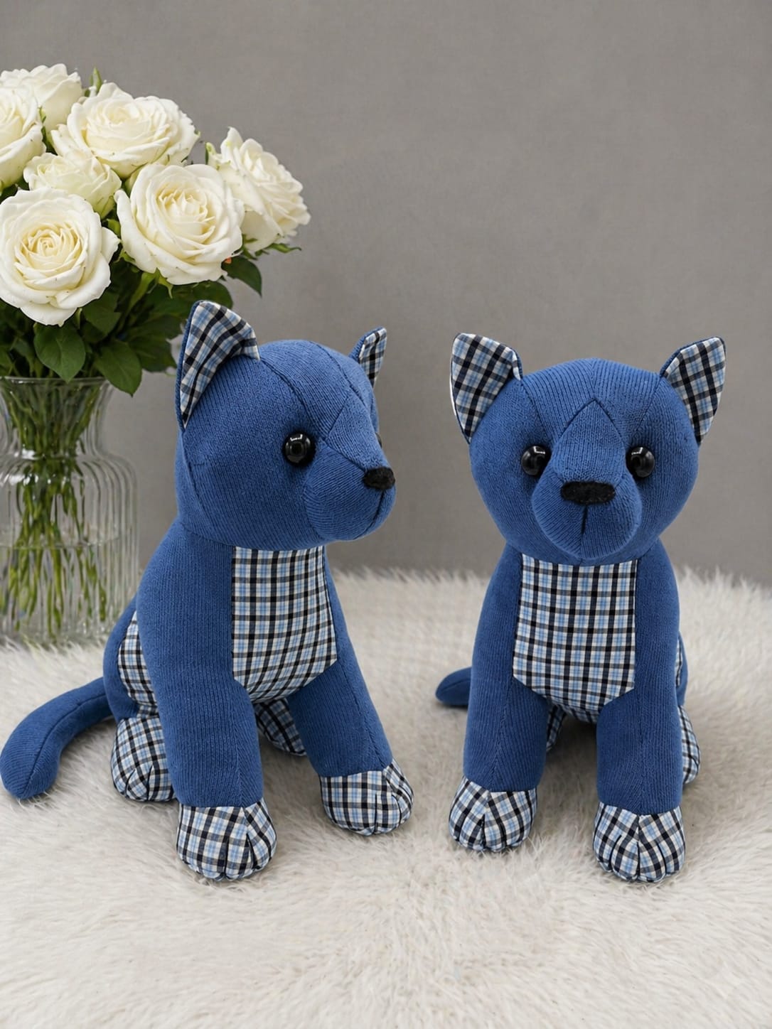 Two blue memory sitting cats with checked fabric details and white roses