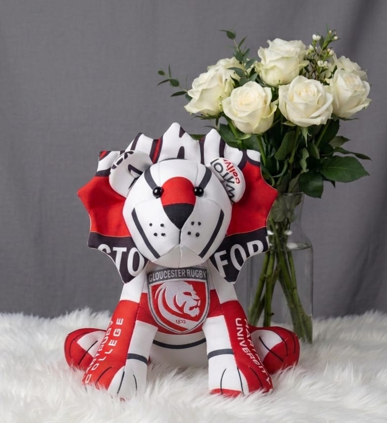 Memory lion sewn from red and white football scarves