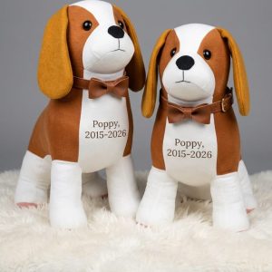 Two memory spaniels with bow ties and embroidered chests reading Poppy 2015 to 2028
