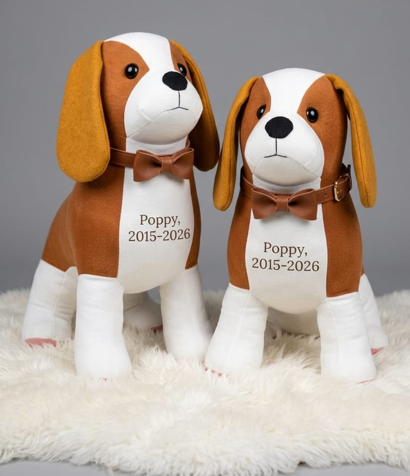 Two memory spaniels with bow ties and embroidered chests reading Poppy 2015 to 2028