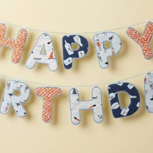 Blue patterned Happy Birthday fabric banner hung in two rows